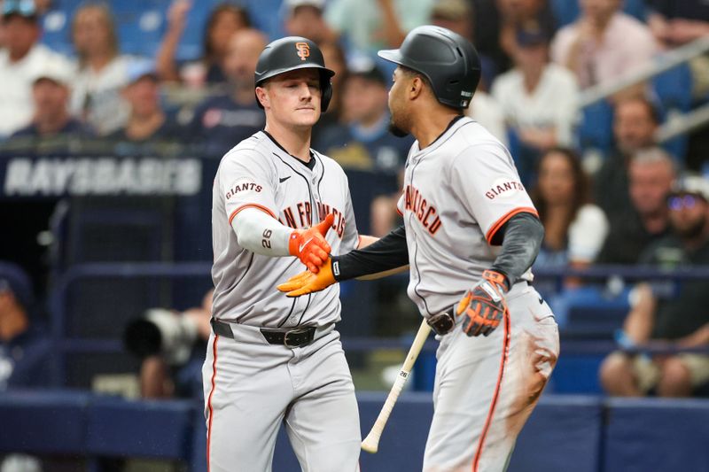 Apr 13, 2024; St. Petersburg, Florida, USA;  San Francisco Giants third baseman Matt Chapman (26) congratulates first baseman LaMonte Wade Jr. (31) after scoring a run against the Tampa Bay Rays in the first inning at Tropicana Field. Mandatory Credit: Nathan Ray Seebeck-USA TODAY Sports