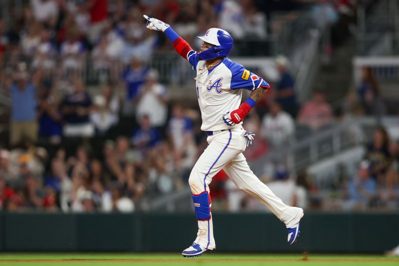 Aug 24, 2024; Atlanta, Georgia, USA; Atlanta Braves shortstop Orlando Arcia (11) celebrates after a home run against the Washington Nationals in the fifth inning at Truist Park. Mandatory Credit: Brett Davis-USA TODAY Sports