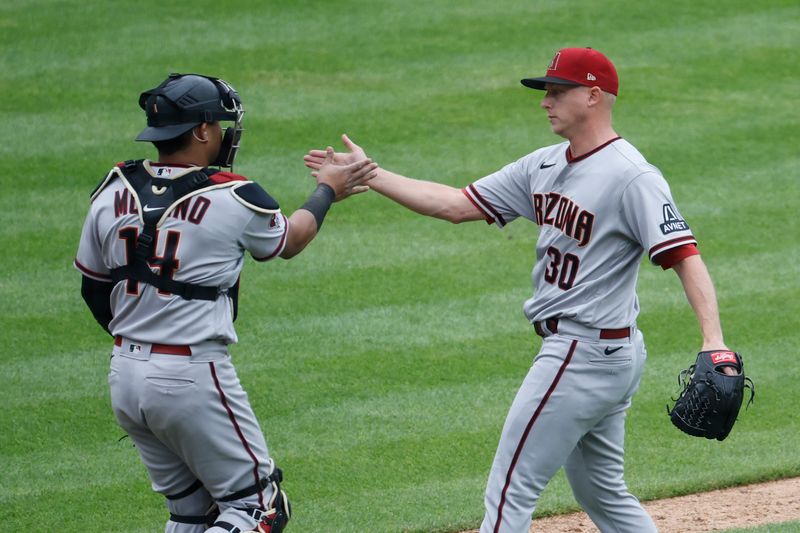 Jun 11, 2023; Detroit, Michigan, USA;  Arizona Diamondbacks catcher Gabriel Moreno (14) and relief pitcher Scott McGough (30) celebrate after defeating the Detroit Tigers at Comerica Park. Mandatory Credit: Rick Osentoski-USA TODAY Sports