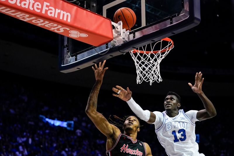 Feb 7, 2026; Provo, Utah, USA; BYU Cougars forward Keba Keita (13) defends a shot from Houston Cougars guard Kingston Flemings (4) during the second half  at Marriott Center. Mandatory Credit: Aaron Baker-Imagn Images