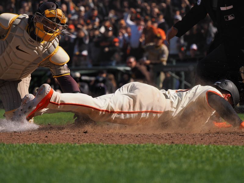 Apr 5, 2024; San Francisco, California, USA; San Francisco Giants third baseman Matt Chapman (26) slides safely home against San Diego Padres catcher Luis Campusano (12) for a walk-off win during the ninth inning at Oracle Park. Mandatory Credit: Kelley L Cox-USA TODAY Sports