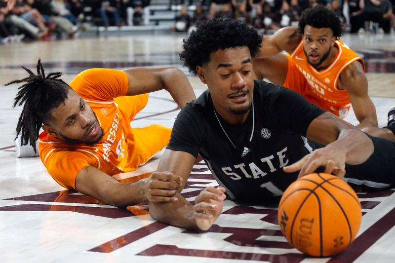 Jan 17, 2023; Starkville, Mississippi, USA; Tennessee Volunteers forward Jonas Aidoo (0) and Mississippi State Bulldogs forward Tolu Smith (1) battle for a loose ball during the second half at Humphrey Coliseum. Mandatory Credit: Petre Thomas-USA TODAY Sports