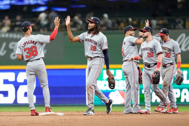 Jul 12, 2024; Milwaukee, Wisconsin, USA;  Washington Nationals left fielder James Wood (29) high fives third baseman Trey Lipscomb (38) following the game against the Milwaukee Brewers at American Family Field. Mandatory Credit: Jeff Hanisch-USA TODAY Sports