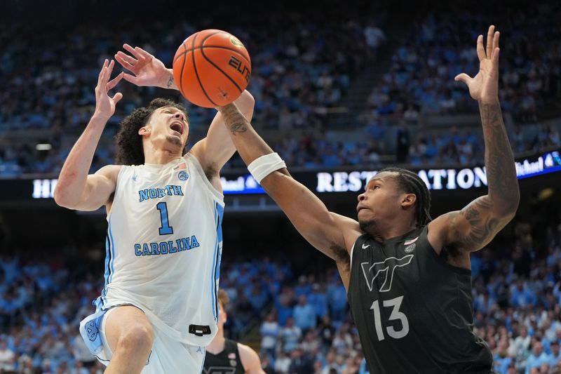Feb 28, 2026; Chapel Hill, North Carolina, USA; North Carolina Tar Heels forward Zayden High (1) is fouled b Virginia Tech Hokies forward Amani Hansberry (13) in the second half at Dean E. Smith Center. Mandatory Credit: Bob Donnan-Imagn Images