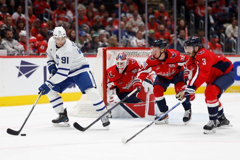 Nov 13, 2024; Washington, District of Columbia, USA; Toronto Maple Leafs center John Tavares (91) controls the puck in front of Washington Capitals goaltender Logan Thompson (48) as Capitals defenseman Rasmus Sandin (38) defends in the second period at Capital One Arena. Mandatory Credit: Geoff Burke-Imagn Images