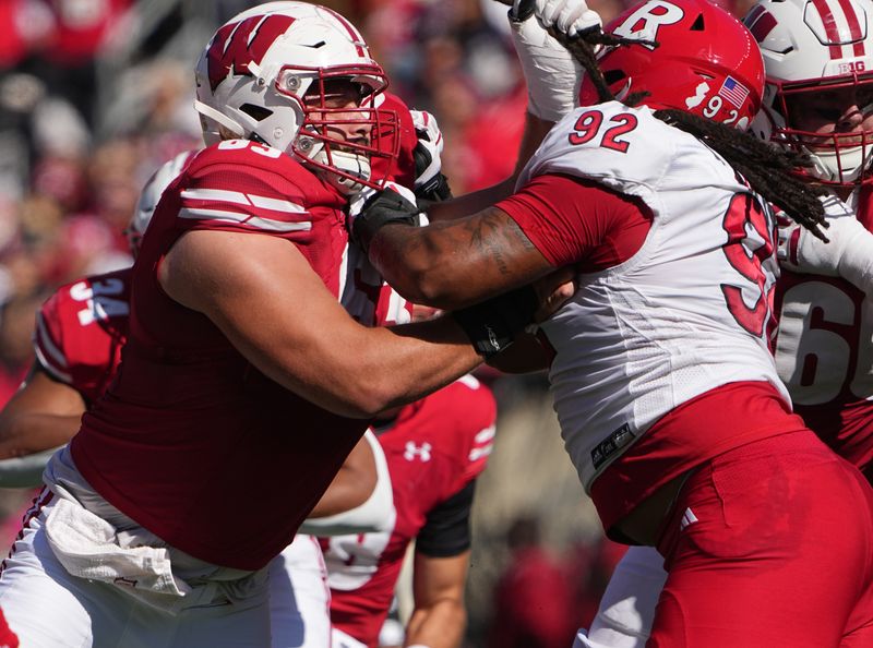 Oct 7, 2023; Madison, Wisconsin, USA; Wisconsin offensive lineman Tanor Bortolini (63) blocks Rutgers defensive lineman Mayan Ahanotu (92) during the second quarter at Camp Randall Stadium. Mandatory Credit: Mark Hoffman-USA TODAY Sports