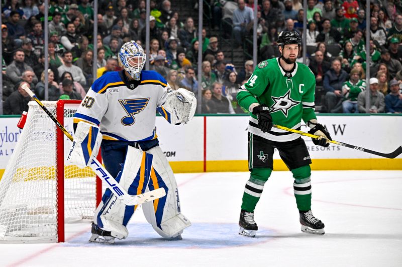 Dec 14, 2024; Dallas, Texas, USA; Dallas Stars left wing Jamie Benn (14) screens St. Louis Blues goaltender Jordan Binnington (50) during the second period at American Airlines Center. Mandatory Credit: Jerome Miron-Imagn Images