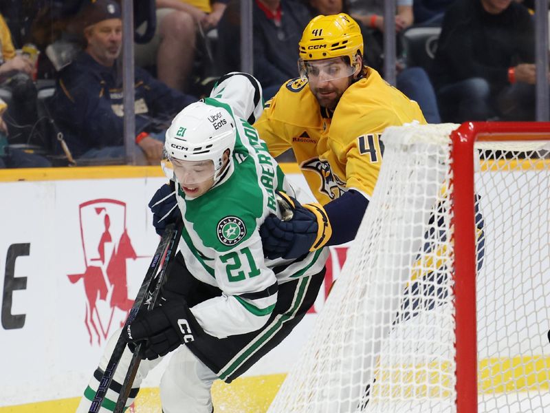 Nov 8, 2025; Nashville, Tennessee, USA; Dallas Stars left wing Jason Robertson (21) drives towards the goal as Nashville Predators defenseman Nicolas Hague (41) defends during the second period at Bridgestone Arena. Mandatory Credit: Alan Poizner-Imagn Images
