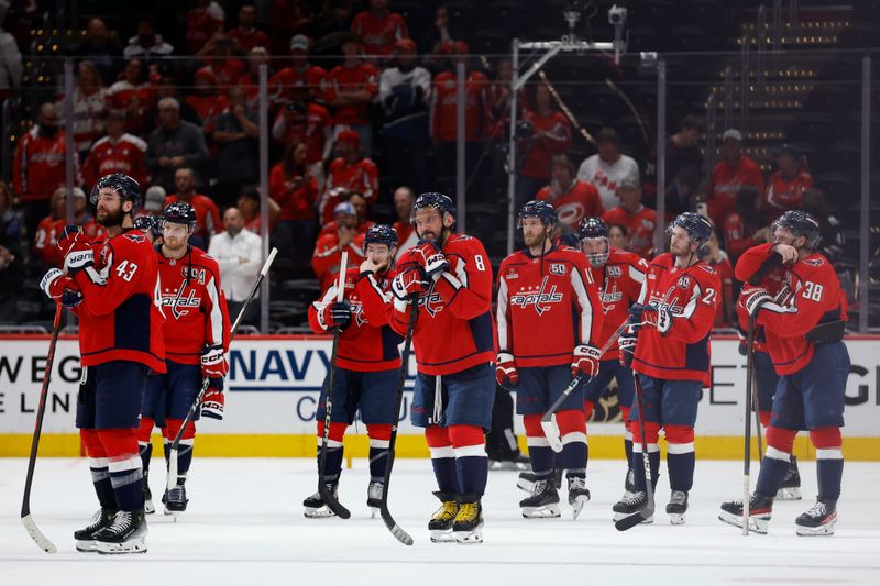 May 15, 2025; Washington, District of Columbia, USA; Washington Capitals players stand on the ice after game five of the second round of the 2025 Stanley Cup Playoffs against the Carolina Hurricanes at Capital One Arena. Mandatory Credit: Geoff Burke-Imagn Images