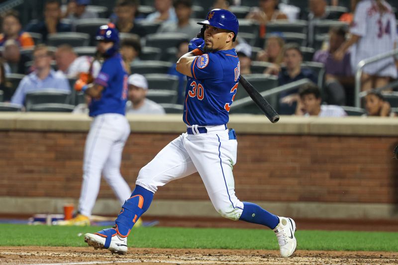 Aug 7, 2023; New York City, New York, USA; New York Mets center fielder Rafael Ortega (30) hits a single during the fifth inning against the Chicago Cubs at Citi Field. Mandatory Credit: Vincent Carchietta-USA TODAY Sports