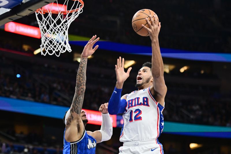 ORLANDO, FLORIDA - JANUARY 19: Tobias Harris #12 of the Philadelphia 76ers shoots the ball against Chuma Okeke #3 of the Orlando Magic in the first half of a game at Kia Center on January 19, 2024 in Orlando, Florida. NOTE TO USER: User expressly acknowledges and agrees that, by downloading and or using this photograph, User is consenting to the terms and conditions of the Getty Images License Agreement. (Photo by Julio Aguilar/Getty Images)