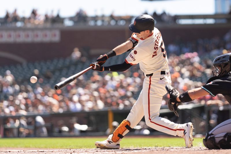 Sep 5, 2024; San Francisco, California, USA;  San Francisco Giants outfielder Mike Yastrzemski (5) hits a single during the first inning against the Arizona Diamondbacks at Oracle Park. Mandatory Credit: Stan Szeto-Imagn Images