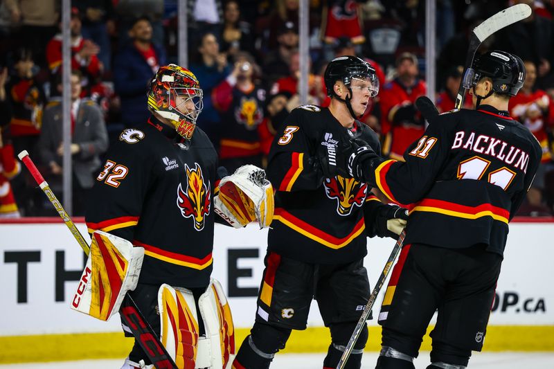 Mar 7, 2026; Calgary, Alberta, CAN; Calgary Flames goaltender Dustin Wolf (32) celebrates win with teammates after defeating Carolina Hurricanes at Scotiabank Saddledome. Mandatory Credit: Sergei Belski-Imagn Images