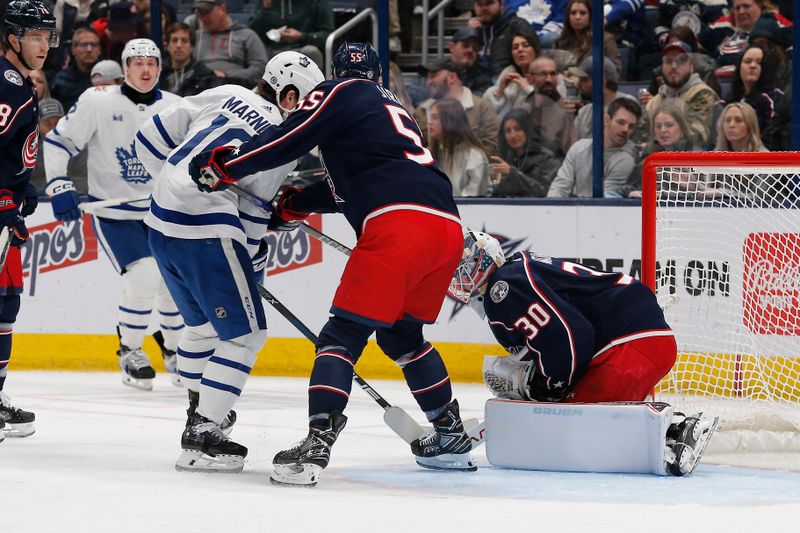 Dec 29, 2023; Columbus, Ohio, USA; Columbus Blue Jackets goalie Spencer Martin (30) makes a save as Toronto Maple Leafs right wing Mitchell Marner (16) looks for a rebound during the second period at Nationwide Arena. Mandatory Credit: Russell LaBounty-USA TODAY Sports