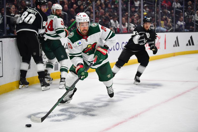 Mar 20, 2024; Los Angeles, California, USA; Minnesota Wild center Frederick Gaudreau (89) moves the puck against the Los Angeles Kings during the second period at Crypto.com Arena. Mandatory Credit: Gary A. Vasquez-USA TODAY Sports