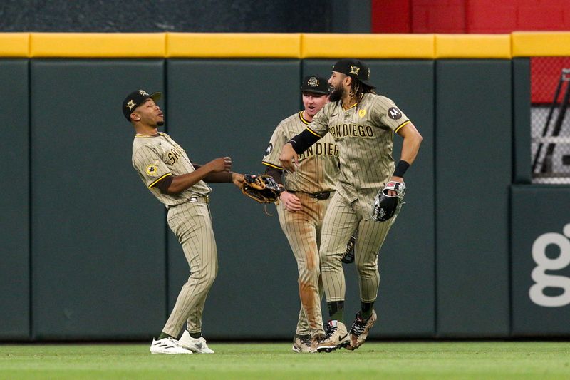 May 17, 2024; Atlanta, Georgia, USA; San Diego Padres left fielder Jose Azocar (28) and center fielder Jackson Merrill (3) and right fielder Fernando Tatis Jr. (23) celebrate after a victory against the Atlanta Braves at Truist Park. Mandatory Credit: Brett Davis-USA TODAY Sports