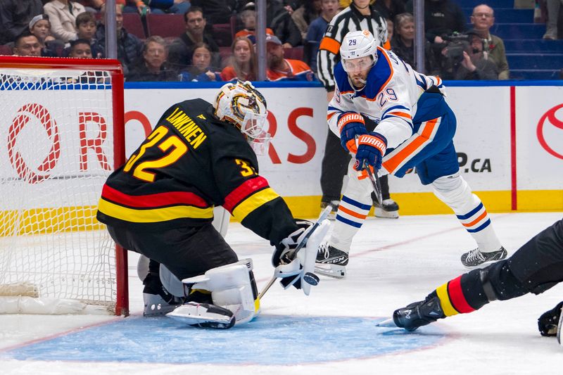 Nov 9, 2024; Vancouver, British Columbia, CAN; Vancouver Canucks goalie Kevin Lankinen (32) makes a save against Edmonton Oilers forward Leon Draisaitl (29) during the first period at Rogers Arena. Mandatory Credit: Bob Frid-Imagn Images