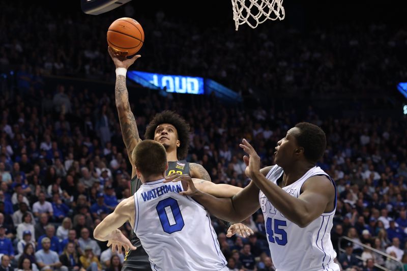 Feb 20, 2024; Provo, Utah, USA; Baylor Bears forward Jalen Bridges (rear) shoots over Brigham Young Cougars forward Noah Waterman (0) and forward Fousseyni Traore (45) during the first half  at Marriott Center. Mandatory Credit: Rob Gray-USA TODAY Sports