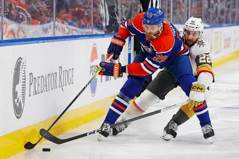 Apr 10, 2024; Edmonton, Alberta, CAN; Edmonton Oilers forward Leon Draisaitl (29) protects the puck from Vegas Golden Knights forward Michael Amadio (22) during the third period at Rogers Place. Mandatory Credit: Perry Nelson-USA TODAY Sports