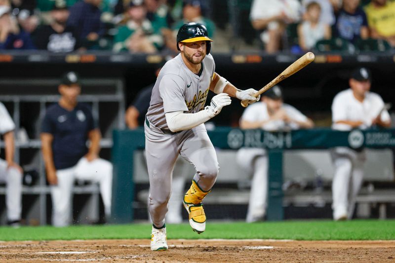 Sep 14, 2024; Chicago, Illinois, USA; Oakland Athletics shortstop Max Schuemann (12) doubles against the Chicago White Sox during the sixth inning at Guaranteed Rate Field. Mandatory Credit: Kamil Krzaczynski-Imagn Images