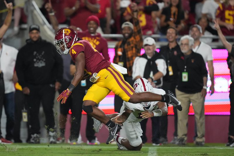 Sep 9, 2023; Los Angeles, California, USA; Southern California Trojans safety Max Williams (4) carries the ball on an interception return against the Stanford Cardinal in the first half at United Airlines Field at Los Angeles Memorial Coliseum. Mandatory Credit: Kirby Lee-USA TODAY Sports