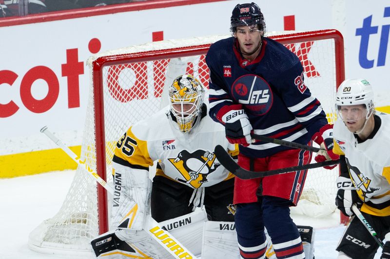 Feb 10, 2024; Winnipeg, Manitoba, CAN;  Winnipeg Jets forward Sean Monahan (23) tries to screen Pittsburgh Penguins goalie Tristan Jarry (35) during the third period at Canada Life Centre. Mandatory Credit: Terrence Lee-USA TODAY Sports