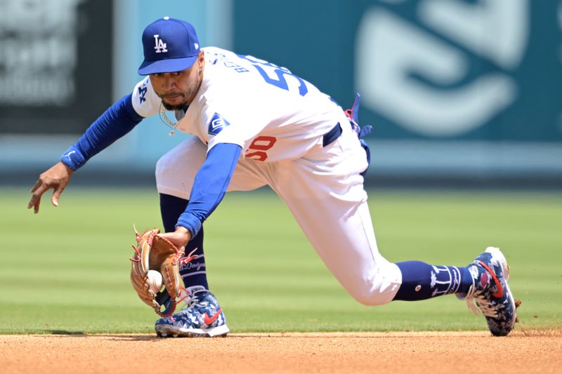 Apr 17, 2024; Los Angeles, California, USA; Los Angeles Dodgers shortstop Mookie Betts (50) makes a play and throws Washington Nationals second base Luis García Jr. (2) out at first in the third inning at Dodger Stadium. Mandatory Credit: Jayne Kamin-Oncea-USA TODAY Sports