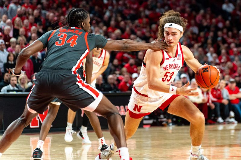 Jan 23, 2024; Lincoln, Nebraska, USA; Nebraska Cornhuskers forward Josiah Allick (53) drives against Ohio State Buckeyes center Felix Okpara (34) during the first half at Pinnacle Bank Arena. Mandatory Credit: Dylan Widger-USA TODAY Sports