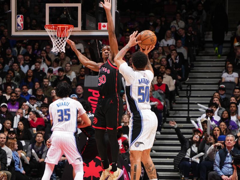 TORONTO, CANADA - JANUARY 3: Cole Anthony #50 of the Orlando Magic shoots the ball during the game against the Toronto Raptors on January 3, 2025 at the Scotiabank Arena in Toronto, Ontario, Canada.  NOTE TO USER: User expressly acknowledges and agrees that, by downloading and or using this Photograph, user is consenting to the terms and conditions of the Getty Images License Agreement.  Mandatory Copyright Notice: Copyright 2025 NBAE(Photo by Mark Blinch/NBAE via Getty Images)