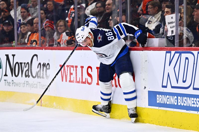 Feb 8, 2024; Philadelphia, Pennsylvania, USA; Winnipeg Jets defenseman Nate Schmidt (88) reacts as he hits the boards against the Philadelphia Flyers in the first period at Wells Fargo Center. Mandatory Credit: Kyle Ross-USA TODAY Sports