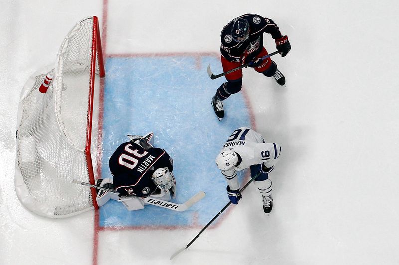 Dec 29, 2023; Columbus, Ohio, USA; Columbus Blue Jackets goalie Spencer Martin (30) makes a save as Toronto Maple Leafs right wing Mitchell Marner (16) looks for a rebound during the second period at Nationwide Arena. Mandatory Credit: Russell LaBounty-USA TODAY Sports