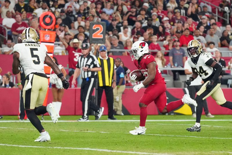 Arizona Cardinals running back Michael Carter (22) carries for a touchdown in the second half of a preseason NFL football game against the New Orleans Saints, Saturday, Aug. 10, 2024, in Glendale, Ariz. (AP Photo/Ross D. Franklin)