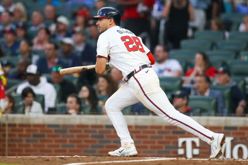 Apr 24, 2024; Atlanta, Georgia, USA; Atlanta Braves first baseman Matt Olson (28) hits a double against the Miami Marlins in the third inning at Truist Park. Mandatory Credit: Brett Davis-USA TODAY Sports