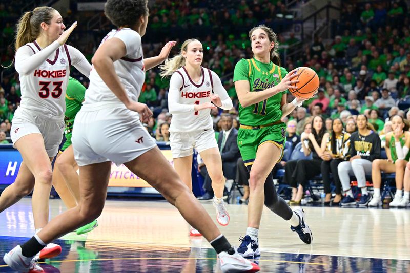 Feb 29, 2024; South Bend, Indiana, USA; Notre Dame Fighting Irish guard Sonia Citron (11) drives to the basket as Virginia Tech Hokies Carleigh Wenzel (1) defends in the second half at the Purcell Pavilion. Mandatory Credit: Matt Cashore-USA TODAY Sports