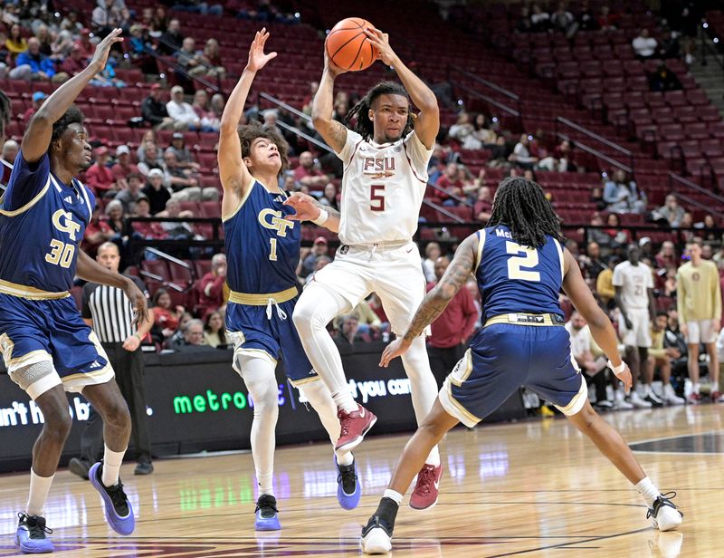 Jan 18, 2025; Tallahassee, Florida, USA; Florida State Seminoles guard Daquan Davis (5) looks to pass the ball against Georgia Tech Yellowjackets guards Javian McCollum (2) and Naithan George (1) during the first half at Donald L. Tucker Center. Mandatory Credit: Robert Myers-Imagn Images