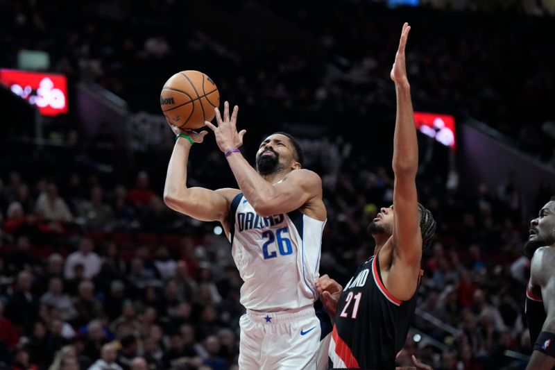 PORTLAND, OREGON - DECEMBER 01: Spencer Dinwiddie #26 of the Dallas Mavericks shoots the ball against Rayan Rupert #21 of the Portland Trail Blazers during the first half at Moda Center on December 01, 2024 in Portland, Oregon. NOTE TO USER: User expressly acknowledges and agrees that, by downloading and or using this photograph, User is consenting to the terms and conditions of the Getty Images License Agreement. (Photo by Soobum Im/Getty Images)