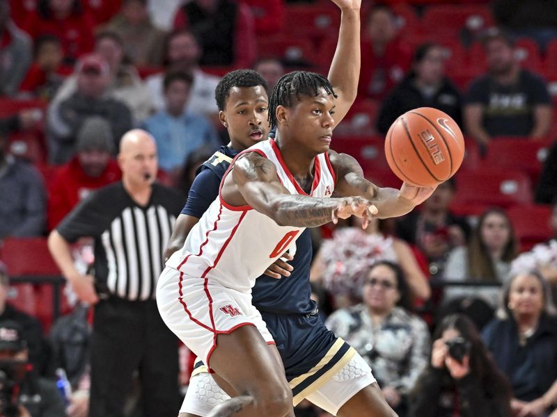 Nov 14, 2022; Houston, Texas, USA; Houston Cougars guard Marcus Sasser (0) passes the ball around Oral Roberts Golden Eagles guard Max Abmas (3) during the first half at Fertitta Center. Mandatory Credit: Maria Lysaker-USA TODAY Sports