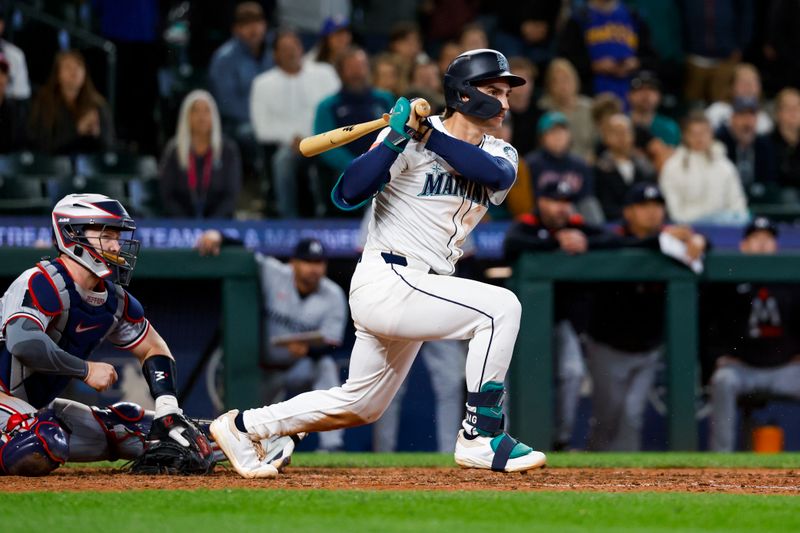 May 31, 2025; Seattle, Washington, USA; Seattle Mariners second baseman Cole Young (2) hits a walk-off RBI-fielders choice against the Minnesota Twins during the eleventh inning at T-Mobile Park. Mandatory Credit: Joe Nicholson-Imagn Images