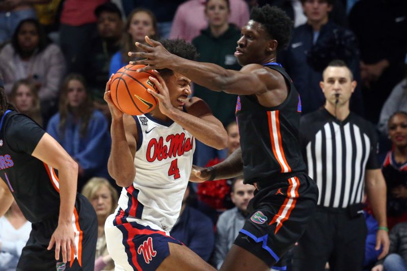 Jan 10, 2024; Oxford, Mississippi, USA; Mississippi Rebels forward Jaemyn Brakefield (4) drives to the basket as Florida Gators forward Tyrese Samuel (4) defends during the first half at The Sandy and John Black Pavilion at Ole Miss. Mandatory Credit: Petre Thomas-USA TODAY Sports