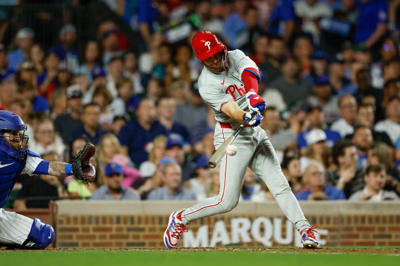 Jul 2, 2024; Chicago, Illinois, USA; Philadelphia Phillies shortstop Trea Turner (7) hits an RBI-single against the Chicago Cubs during the seventh inning at Wrigley Field. Mandatory Credit: Kamil Krzaczynski-USA TODAY Sports