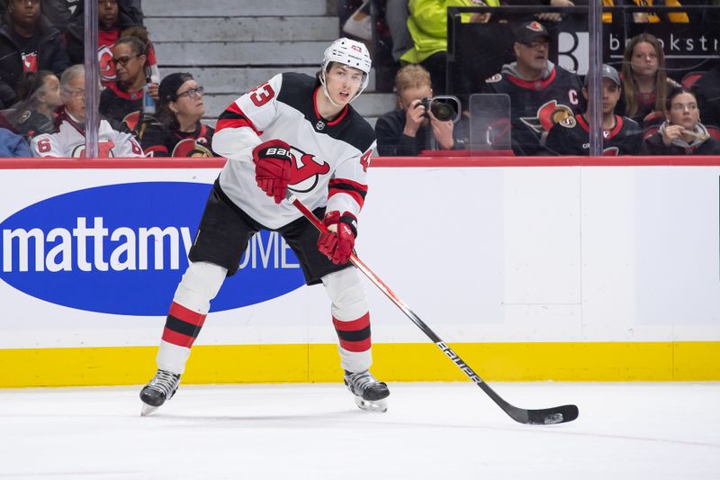 Apr 6, 2024; Ottawa, Ontario, CAN; New Jersey Devils defenseman Luke Hughes (43) moves the puck in the first period against the Ottawa Senators at the Canadian Tire Centre. Mandatory Credit: Marc DesRosiers-USA TODAY Sports