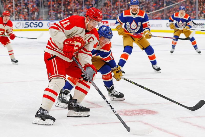 Feb 24, 2024; Edmonton, Alberta, CAN; Calgary Flames forward Michael Backlund (11) carries the puck around Edmonton Oilers forward Derek Ryan (10) during the second period at Rogers Place. Mandatory Credit: Perry Nelson-USA TODAY Sports