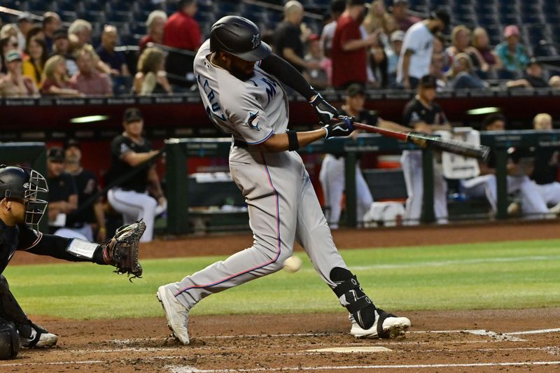 May 8, 2023; Phoenix, Arizona, USA;  Miami Marlins left fielder Bryan De La Cruz (14) it hit in the knee by a foul ball in the fourth inning against the Arizona Diamondbacks at Chase Field. Mandatory Credit: Matt Kartozian-USA TODAY Sports