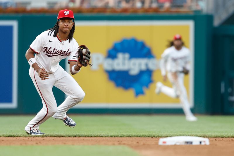 Jul 19, 2024; Washington, District of Columbia, USA; Washington Nationals shortstop CJ Abrams (5) fields a ground ball hit by Cincinnati Reds outfielder Stuart Fairchild (not pictured) during the fifth inning at Nationals Park. Mandatory Credit: Geoff Burke-USA TODAY Sports