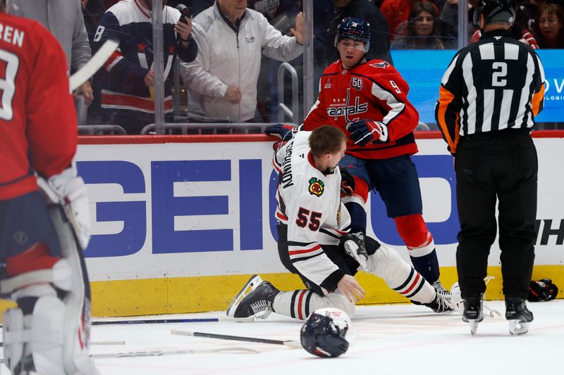 Apr 4, 2025; Washington, District of Columbia, USA; Washington Capitals right wing Ryan Leonard (9) knocks down Chicago Blackhawks defenseman Artyom Levshunov (55) during a scrum in the third period at Capital One Arena. Mandatory Credit: Geoff Burke-Imagn Images