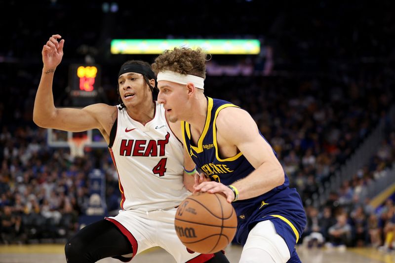 SAN FRANCISCO, CALIFORNIA - DECEMBER 28: Brandin Podziemski #2 of the Golden State Warriors is guarded by R.J. Hampton #4 of the Miami Heat in the second half at Chase Center on December 28, 2023 in San Francisco, California. NOTE TO USER: User expressly acknowledges and agrees that, by downloading and or using this photograph, User is consenting to the terms and conditions of the Getty Images License Agreement.  (Photo by Ezra Shaw/Getty Images)