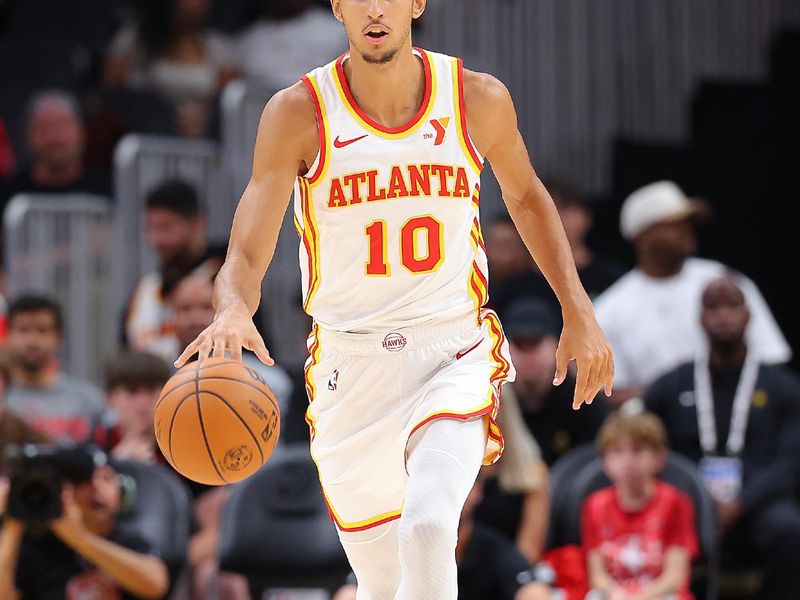 ATLANTA, GEORGIA - OCTOBER 08:  Zaccharie Risacher #10 of the Atlanta Hawks pushes the ball down the court against the Indiana Pacers during the first quarter at State Farm Arena on October 08, 2024 in Atlanta, Georgia.  NOTE TO USER: User expressly acknowledges and agrees that, by downloading and/or using this photograph, user is consenting to the terms and conditions of the Getty Images License Agreement.  (Photo by Kevin C. Cox/Getty Images)