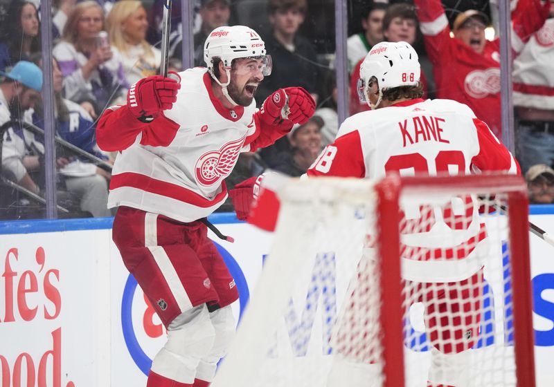 Apr 13, 2024; Toronto, Ontario, CAN; Detroit Red Wings center Dylan Larkin (71) scores the winning goal and celebrates with right wing Patrick Kane (88) against the Toronto Maple Leafs during the overtime period at Scotiabank Arena. Mandatory Credit: Nick Turchiaro-USA TODAY Sports