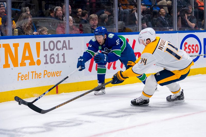 Jan 3, 2025; Vancouver, British Columbia, CAN; Nashville Predators forward Gustav Nyquist (14) stick checks Vancouver Canucks defenseman Guillaume Brisebois (55) in the first period at Rogers Arena. Mandatory Credit: Bob Frid-Imagn Images