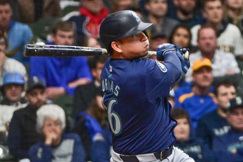 Apr 5, 2024; Milwaukee, Wisconsin, USA; Seattle Mariners second baseman Luis Urias (16) hits a double to drive in a run in the ninth inning against the Milwaukee Brewers at American Family Field. Mandatory Credit: Benny Sieu-USA TODAY Sports